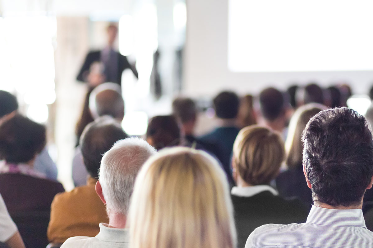 A man lecturing to a full room